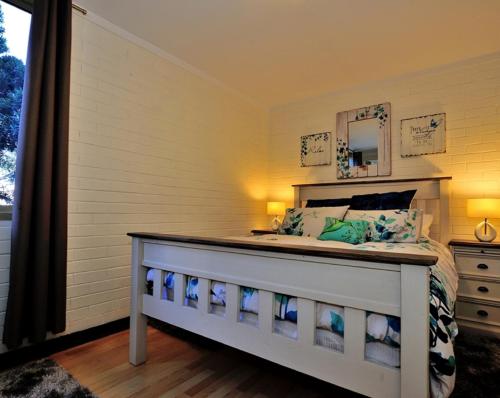 a childs bedroom with a bed and a mirror at Cappuccino Delight - 1 bedroom central Fremantle apartment in Fremantle