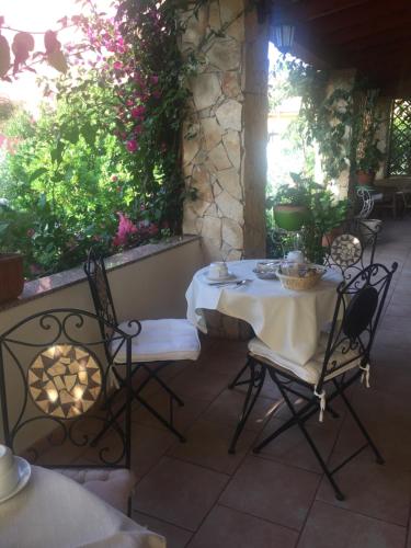 a table and chairs sitting on a patio at La ginestra Chia B&B in Domus de Maria