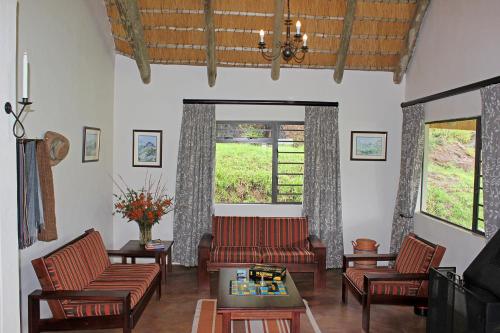 a living room with a couch and chairs and a table at Sungubala Eco Camp in Bergville