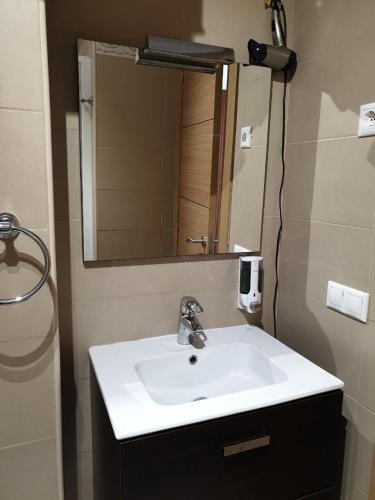a bathroom with a sink and a mirror at Studio El Faro in Torrox Costa