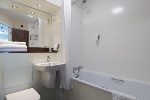 a white bathroom with a sink and a bath tub at Kings Chamber, Doncaster by Marston's Inns in Doncaster