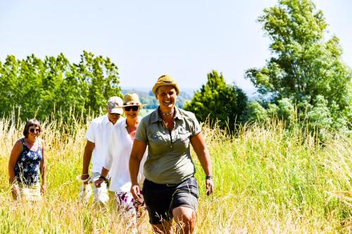a group of people walking through a field at Sydkustens at Pillehill in Skivarp