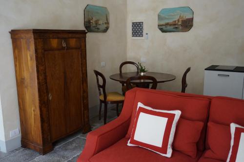 a living room with a red couch and a table at Palazzo Mantua Benavides Suites & Apartments in Padova