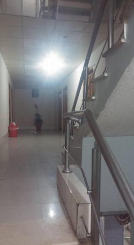 an empty room with a staircase in a building at Shining Star Hotel in Rawalpindi