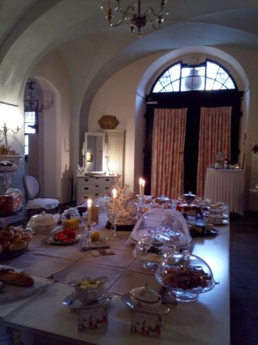 a table with candles and plates of food on it at ApartOne Altstadt-Hotel in Bautzen