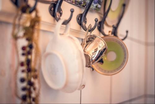 a bunch of kitchen utensils hanging on a wall at ApartOne Altstadt-Hotel in Bautzen