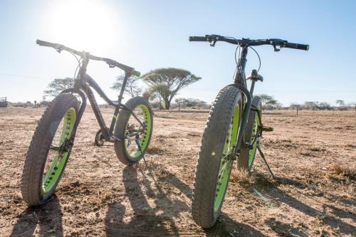 two bikes are parked in a field at Dornhuegel Guest Farm in Groutfontein