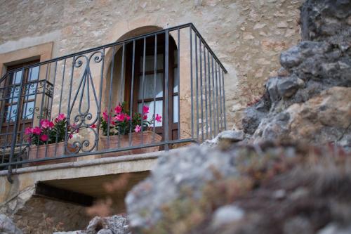a window with pink flowers on a balcony at Charme in Perillis in Popoli