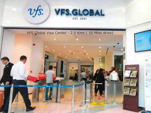 a group of people walking inside of a store at The Grand Uddhav in New Delhi