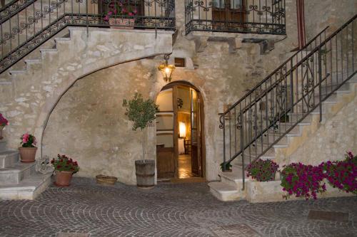 an entrance to a building with stairs and potted plants at Charme in Perillis in Popoli