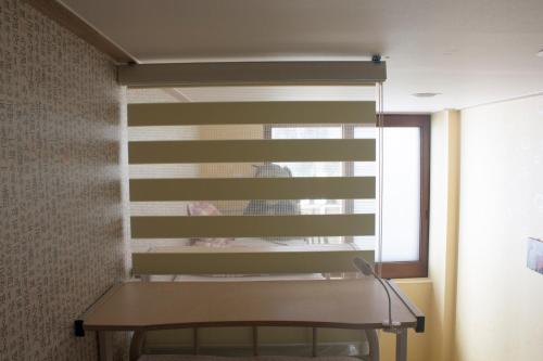 a window in a room with a table and a mirror at Nearest Guesthouse in Jeonju