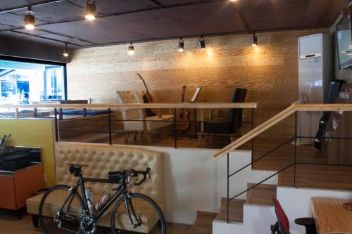 a bike parked in a room with a table at Nearest Guesthouse in Jeonju