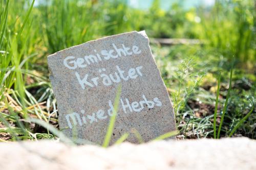 a sign sitting on the ground in the grass at Dornhuegel Guest Farm in Groutfontein