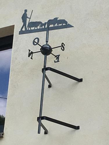 a clock on the side of a building at Le Pailhé de Marius in La Salvetat