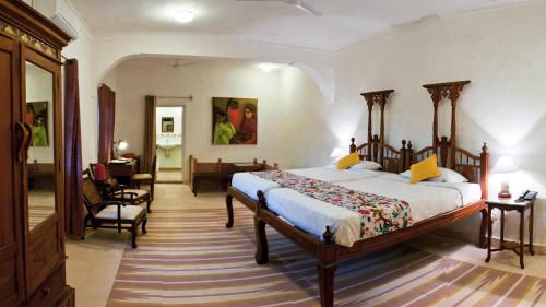 a bedroom with a bed and a living room at Neemrana's - Hill Fort - Kesroli in Alwar