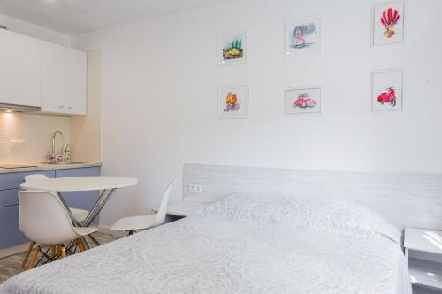 a bedroom with a bed and a table and chairs at Sunny apartments on Yulii Zdanovskoi st 36b in Kyiv