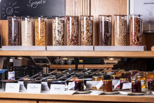 a display of different types of food on a shelf at B&B Appartement Das Stoaberg in Leogang