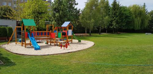 a playground with colorful playground equipment in a park at Eurohotel Swarzędz in Swarzędz