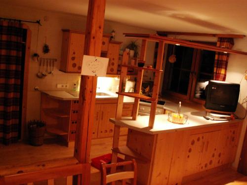 a kitchen with a bunk bed and a desk with a television at Bioferienhof Brückler in Laussa