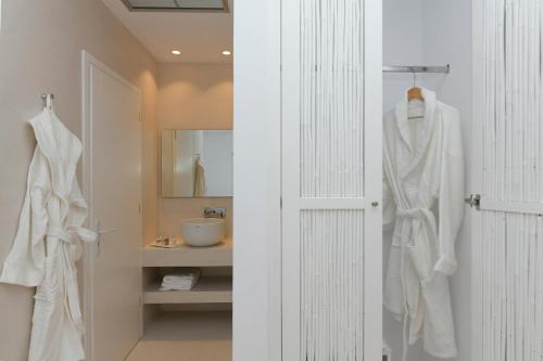 a bathroom with a white towel hanging on the wall at The Ammonite Resort in Super Paradise Beach