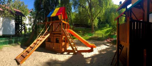 a playground with a slide and a slideintend at Hotel Complex Turistic Magura in Măgura