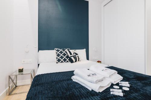 a bedroom with a bed with towels on it at Epalza apartment by People Rentals in Bilbao