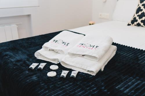 two towels with the words for me are on a bed at Epalza apartment by People Rentals in Bilbao