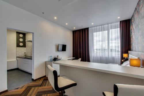 a hotel room with a reception desk and chairs at Sunflower Hotel Vnukovo in Moskovsky
