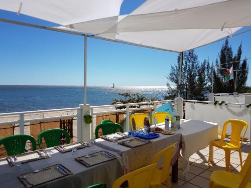a table on a balcony with a view of the ocean at Somaroala in Mahajanga