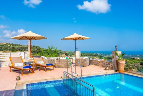 a swimming pool with chairs and umbrellas on a roof at Villa Kantifes 4 Families or Couples with Private Pool & BBQ in Kiriánna