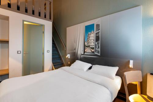 Postel nebo postele na pokoji v ubytování B&B HOTEL Angers 1 Beaucouzé