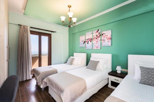 two beds in a room with green walls at New Villa Kantifes 4 Families or Couples with Private Pool & BBQ in Kiriánna