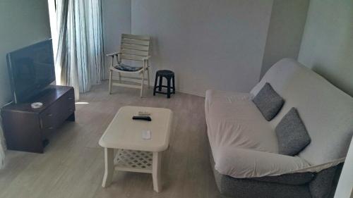 a living room with a couch and a table at Apartman Ana in Igalo