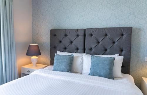 a bedroom with a large bed with blue walls at Karma St. Martin's in St Martins
