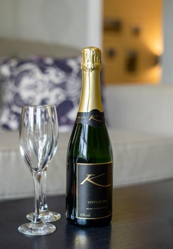 a bottle of champagne next to a wine glass at Karma St. Martin's in St Martins