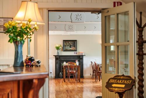 a kitchen and dining room with a table and chairs at Hylands Burren Hotel in Ballyvaughan