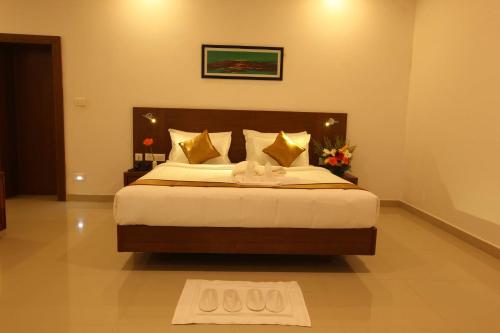 a bedroom with a large bed in a room at Victory Inn Park Residency in Kunnamkulam