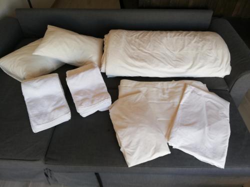 a bed with white sheets and pillows on it at Lopes Apartment - Belch1952 in Lagos