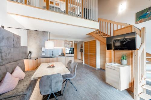 a kitchen and living room with a table and a television at Hotel Andy 4 Sterne Superior in Jerzens