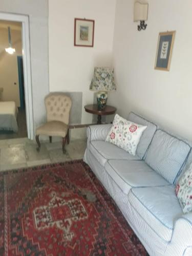 a living room with a couch and a table at B&B Vecchia Suppenna in Andria