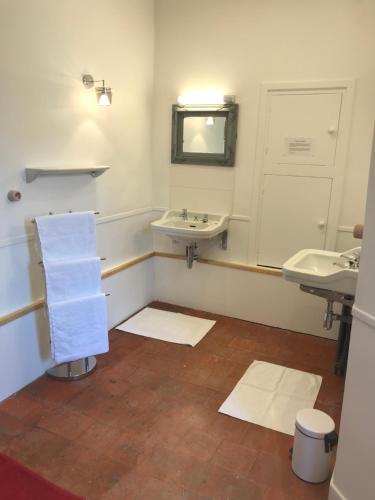a bathroom with two sinks and a mirror at La Menuiserie in Épernay