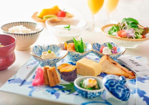 a blue and white plate of food on a table at Royal Park Hotel Takamatsu in Takamatsu