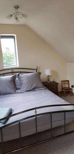 1 dormitorio con 1 cama grande y ventana en The Old School Loft, en Blidworth