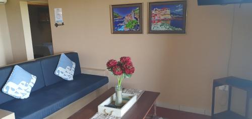a living room with a blue couch and a table at Go Wild Beach Resort in Xai-Xai