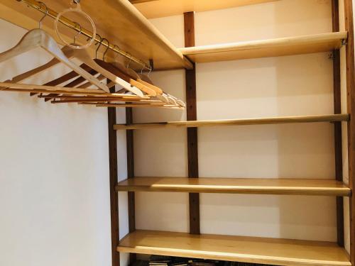 a walk in closet with wooden shelves at Villamoreno in Merlara