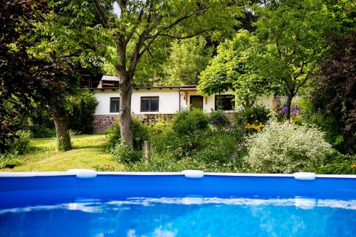 a house with a blue pool in front of it at AppartChalet LA RONDULA - 100m from Seceda in Ortisei
