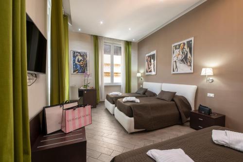 a hotel room with two beds and a flat screen tv at Mia Resort in Rome