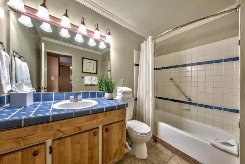 a bathroom with a sink and a tub and a toilet at Forest Suites Resort at the Heavenly Village in South Lake Tahoe