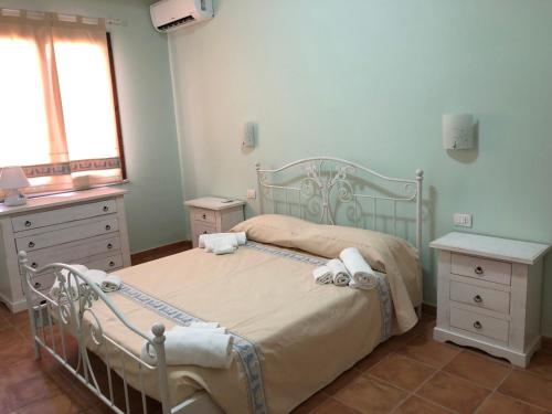 a bedroom with a hospital bed and a window at Sa Corti Antiga Apartment in SantʼAntìoco