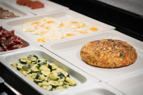 a table with trays of different types of food at Catalonia Born in Barcelona